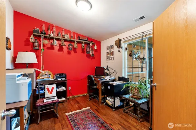 a reading room with furniture a rug and a window