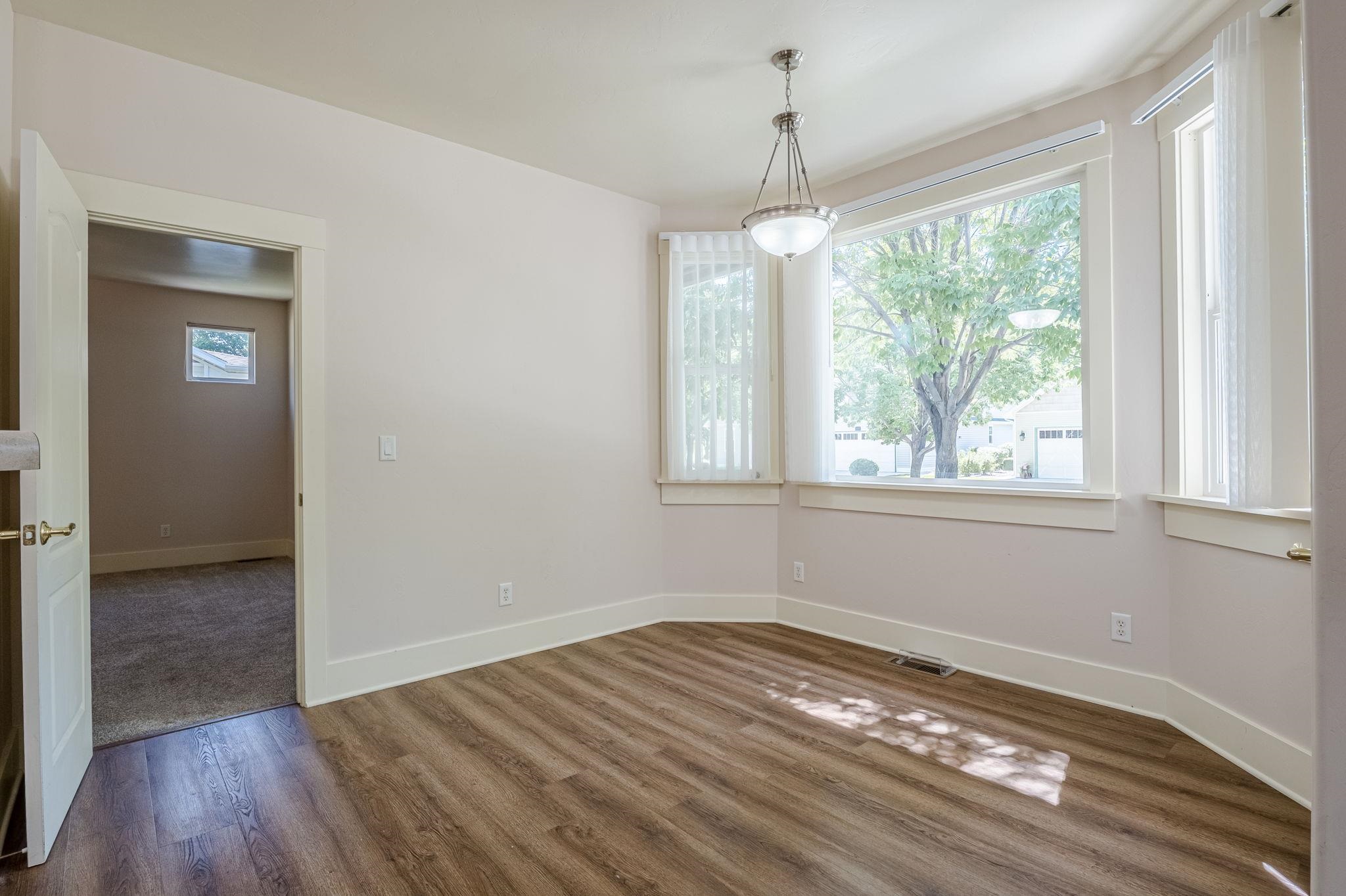 812 Alyssum Court Fruita, CO 81521 - Photo 11 of 41 a view of empty room with wooden floor and fan