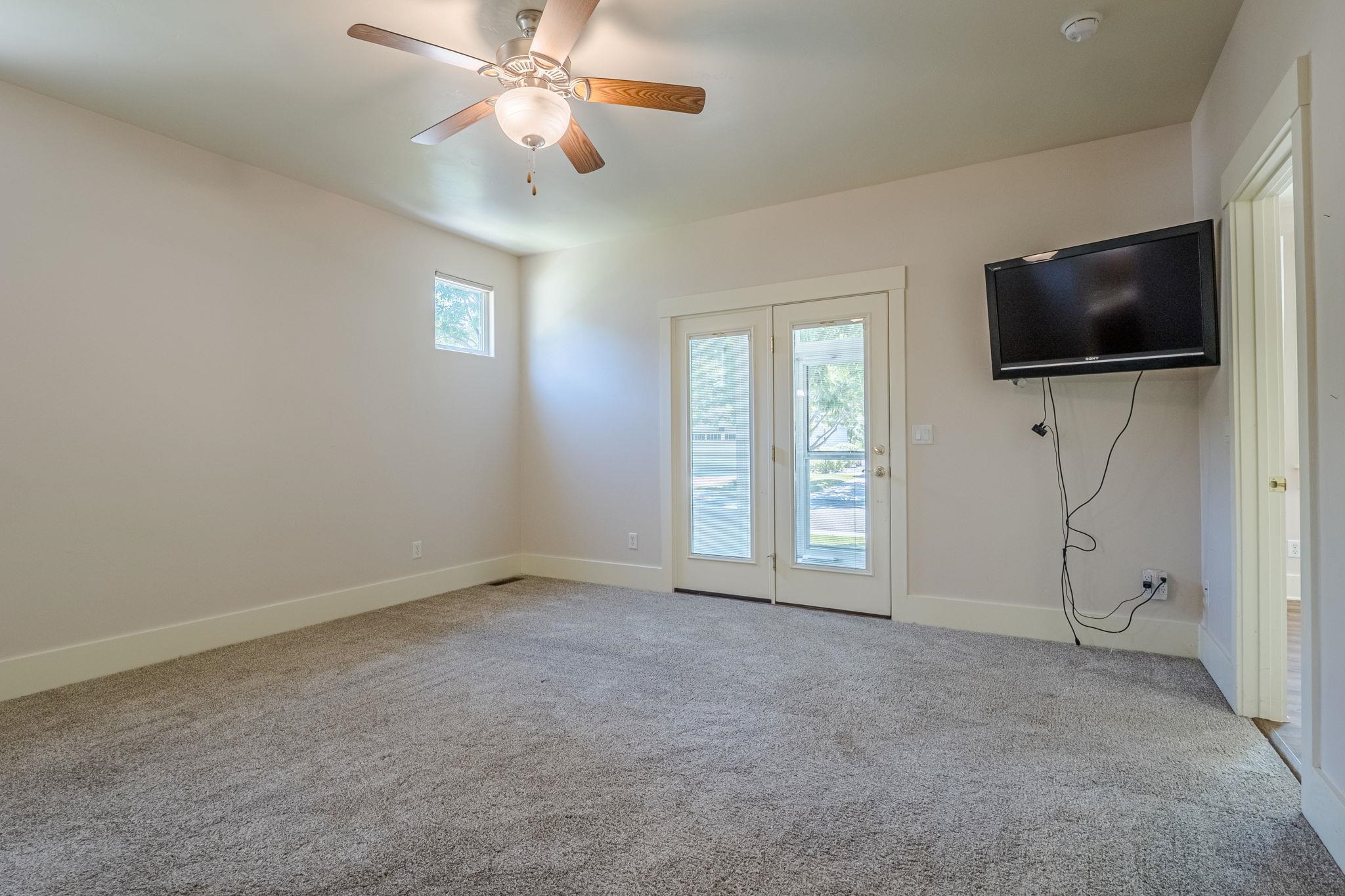 812 Alyssum Court Fruita, CO 81521 - Photo 17 of 41 a view of livingroom with flat screen tv ceiling fan and windows