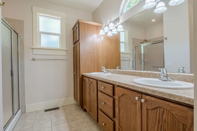 a bathroom with a double vanity sink and a mirror