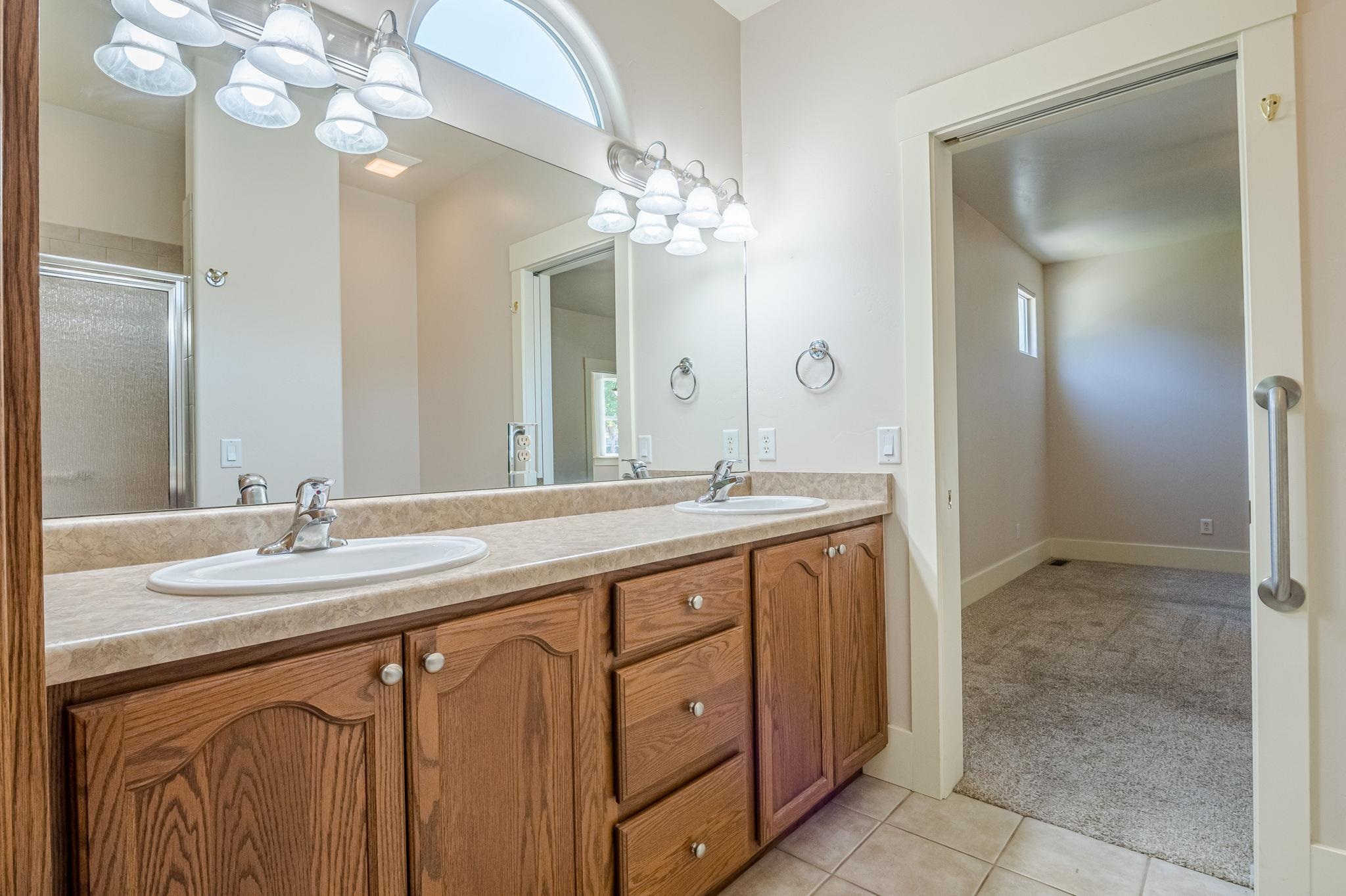 812 Alyssum Court Fruita, CO 81521 - Photo 22 of 41 a bathroom with a sink vanity and a mirror