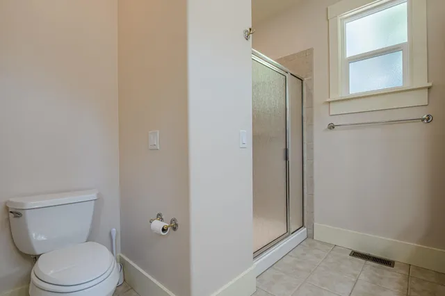 a white toilet sitting next to a window