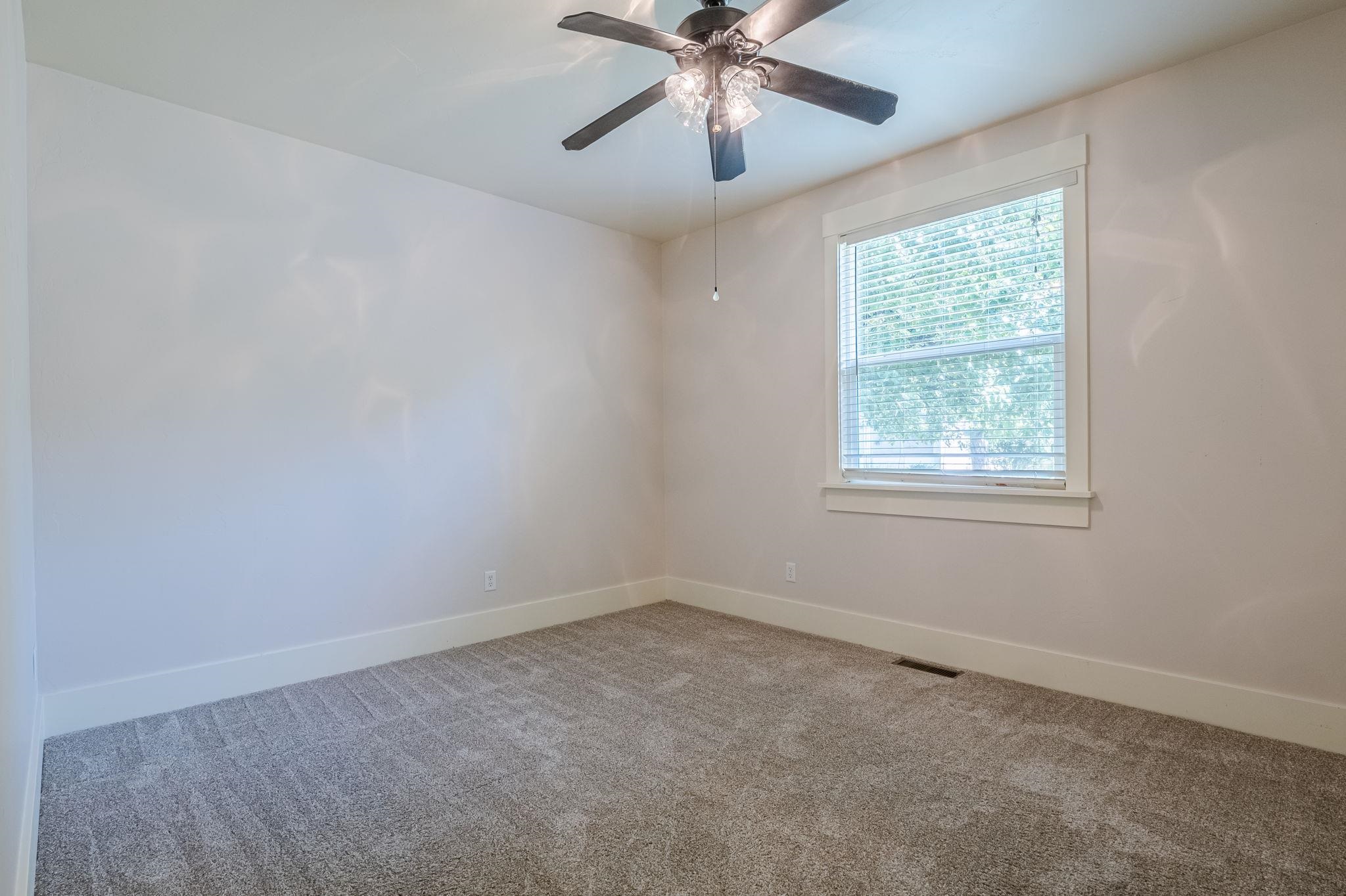 812 Alyssum Court Fruita, CO 81521 - Photo 29 of 41 an empty room with a window and a fan