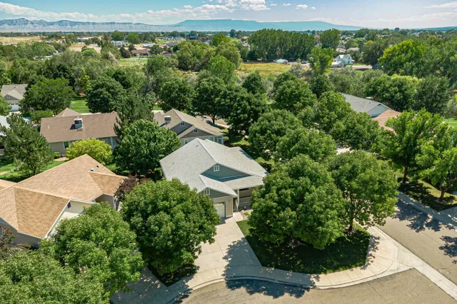 an aerial view of a house with a yard and lake view