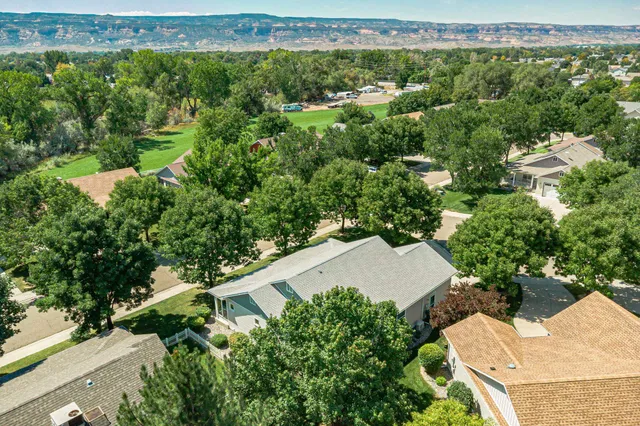 an aerial view of a house with a yard