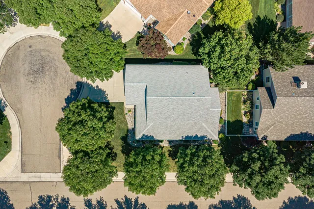 an aerial view of a house with a yard and potted plants