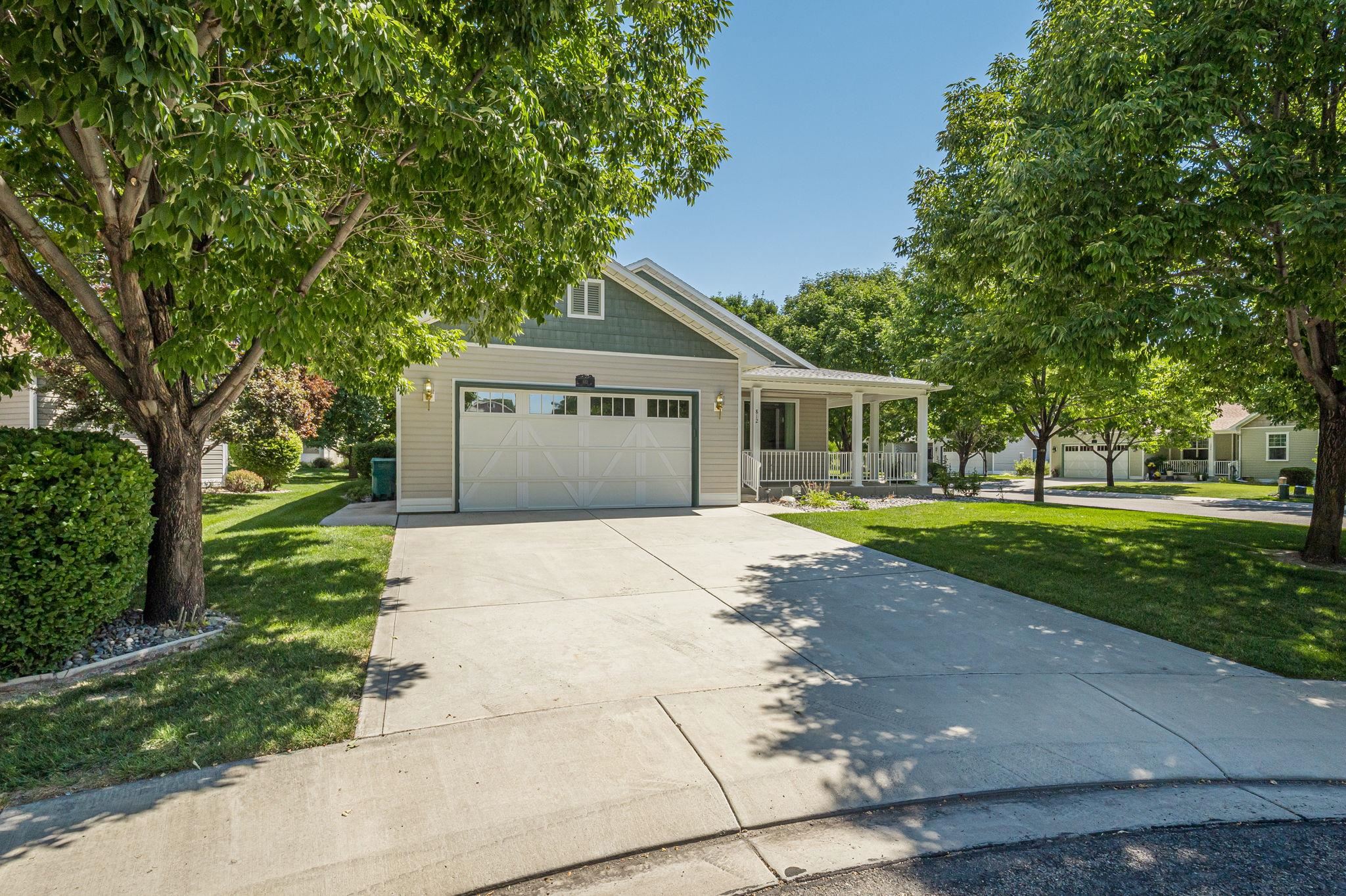 812 Alyssum Court Fruita, CO 81521 - Photo 40 of 41 a front view of a house with a garden and trees
