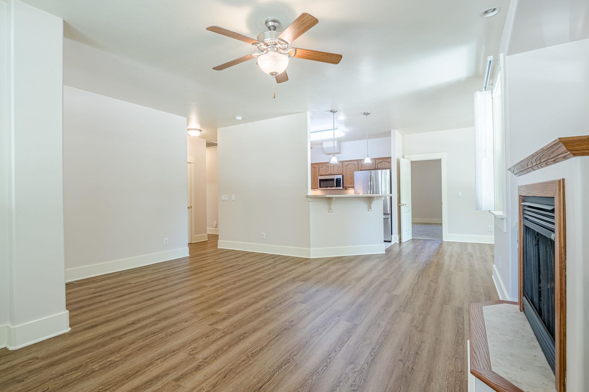 812 Alyssum Court Fruita, CO 81521 - Photo 8 of 41 a view of a kitchen with wooden floor and a ceiling fan