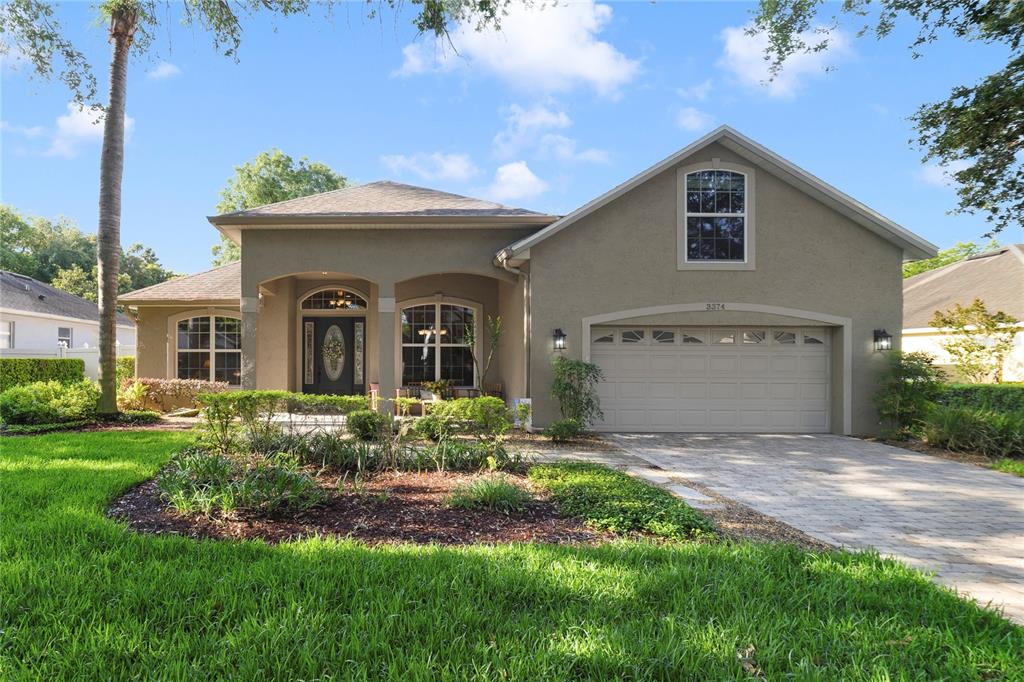 a view of a house with a yard and garden