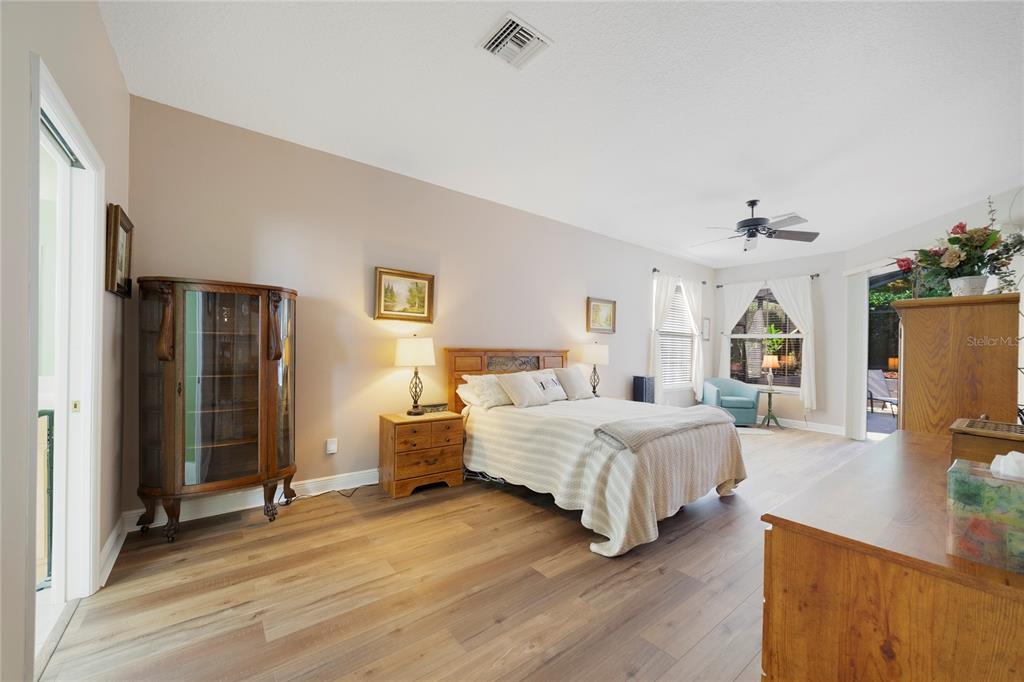 3374 Furlong Way Gotha, FL 34734 - Photo 15 of 38 a spacious bedroom with a bed and a dresser with wooden floor