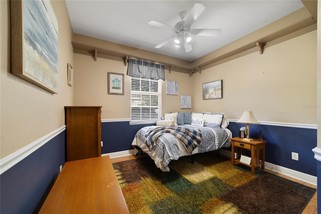 3374 Furlong Way Gotha, FL 34734 - Photo 19 of 38 a bedroom with a bed and a chandelier