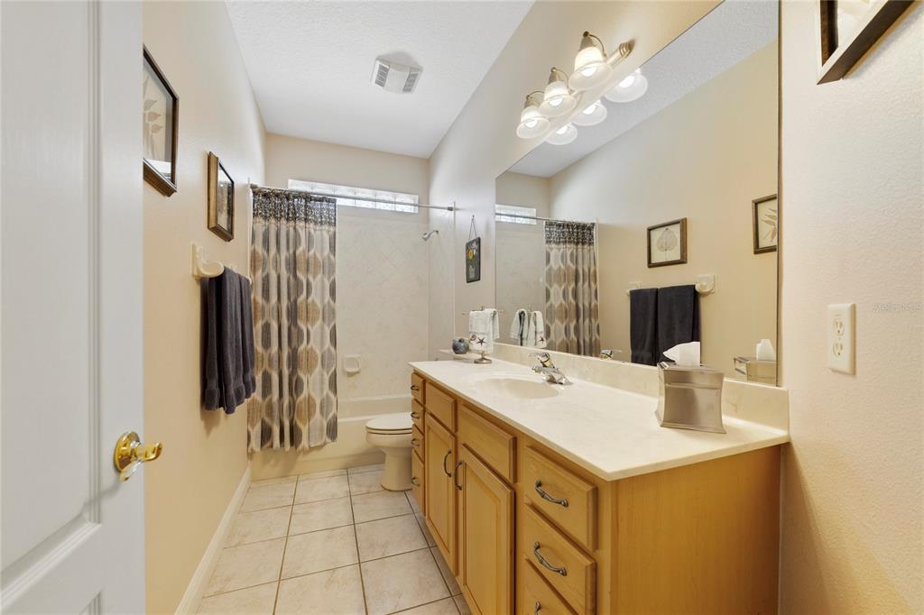 3374 Furlong Way Gotha, FL 34734 - Photo 20 of 38 a bathroom with a sink vanity granite tub shower and a mirror