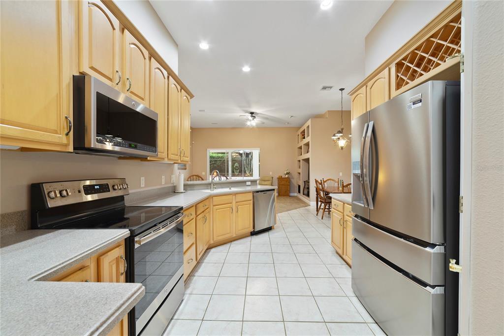 3374 Furlong Way Gotha, FL 34734 - Photo 8 of 38 a kitchen with stainless steel appliances granite countertop a refrigerator a stove top oven and a sink