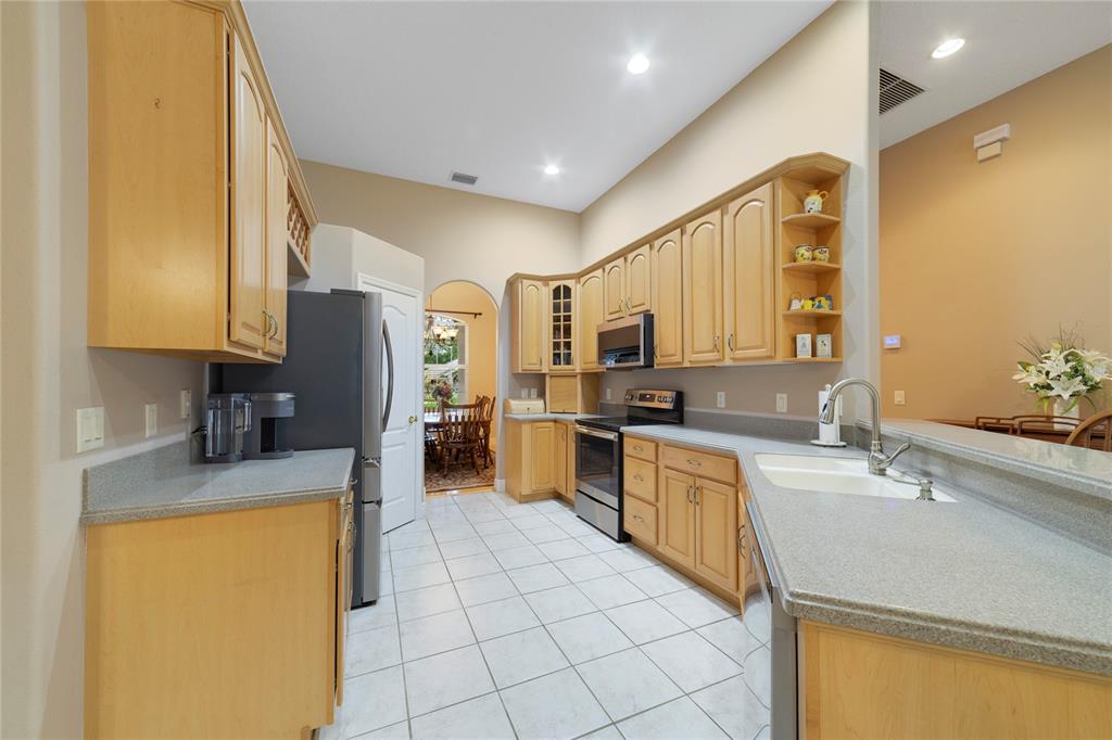 3374 Furlong Way Gotha, FL 34734 - Photo 9 of 38 a kitchen with a sink a stove top oven and refrigerator