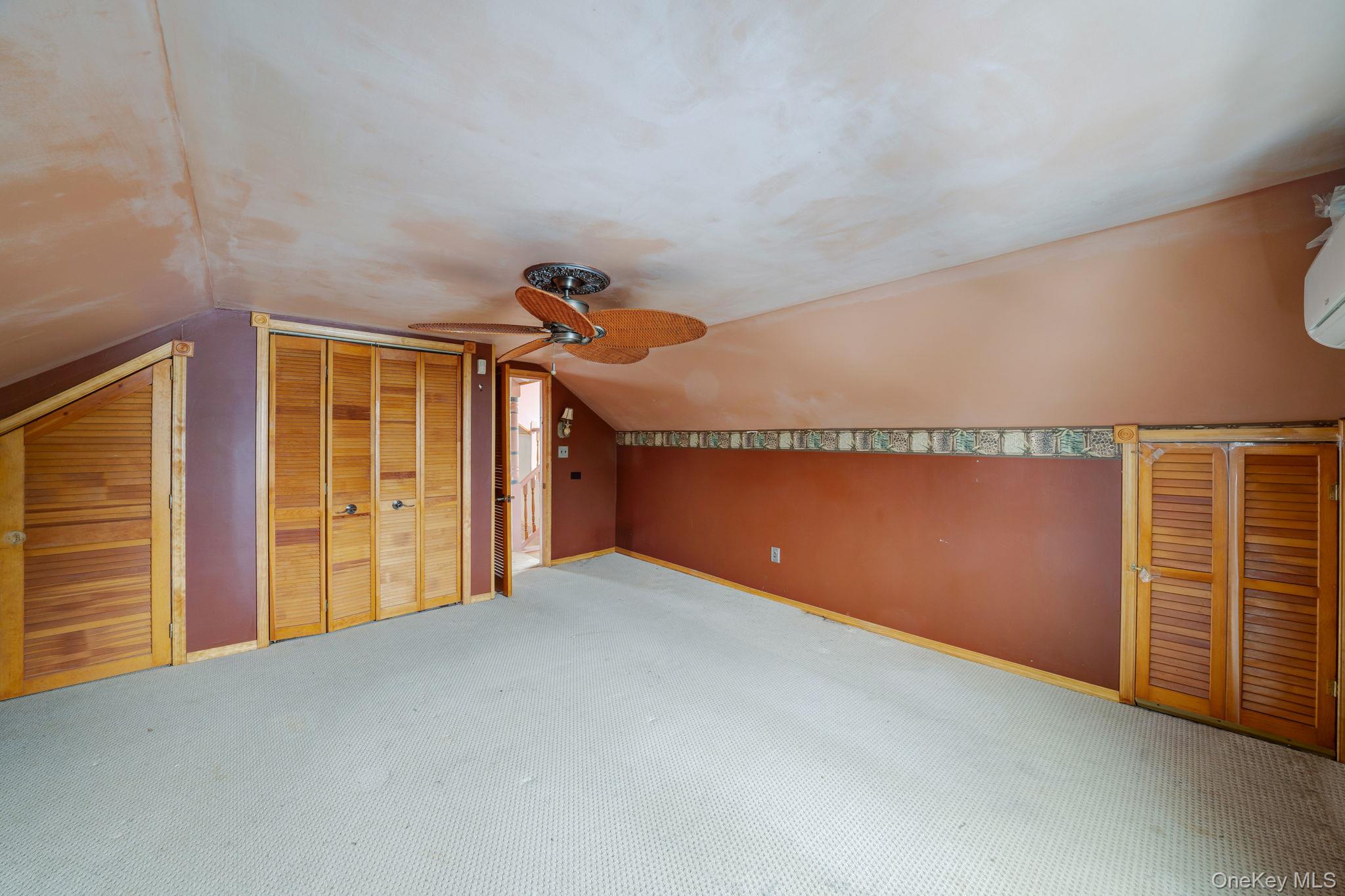 778 Terry Road Hauppauge, NY 11788 - Photo 25 of 29 Additional living space with lofted ceiling, carpet flooring, and a ceiling fan
