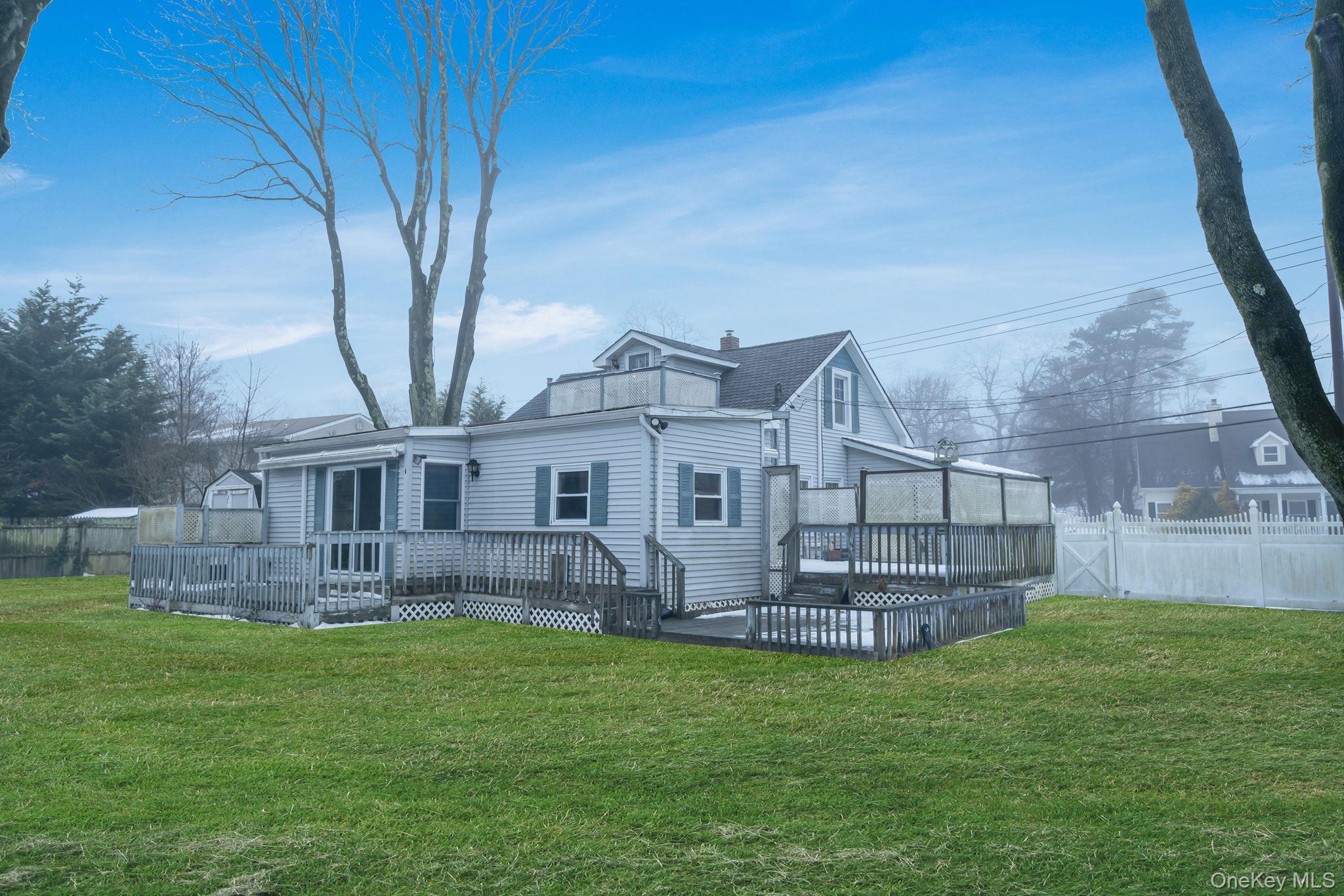 778 Terry Road Hauppauge, NY 11788 - Photo 27 of 29 Rear view of house featuring a deck and a chimney