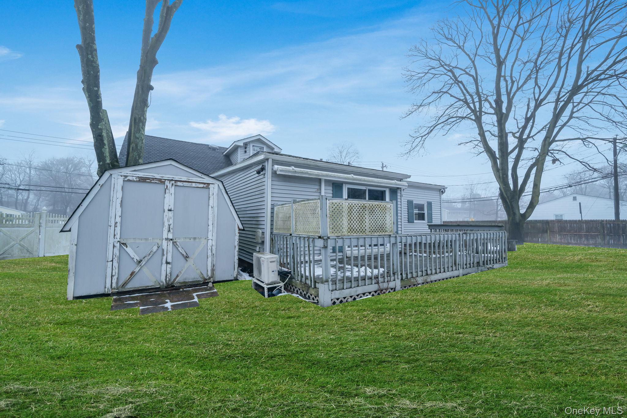 778 Terry Road Hauppauge, NY 11788 - Photo 28 of 29 Back of house with a wooden deck and a shed