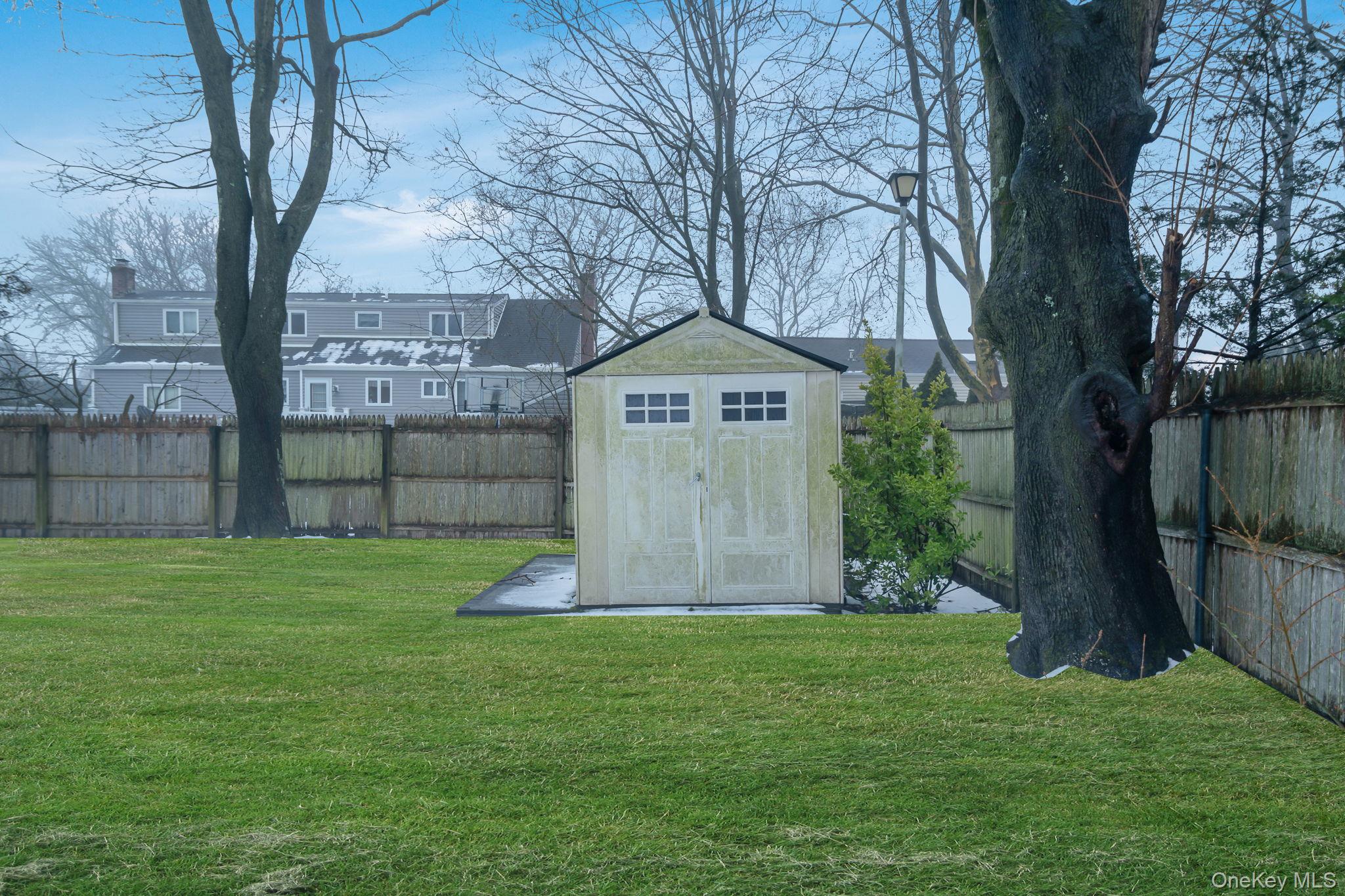 778 Terry Road Hauppauge, NY 11788 - Photo 29 of 29 Fenced backyard featuring a storage unit