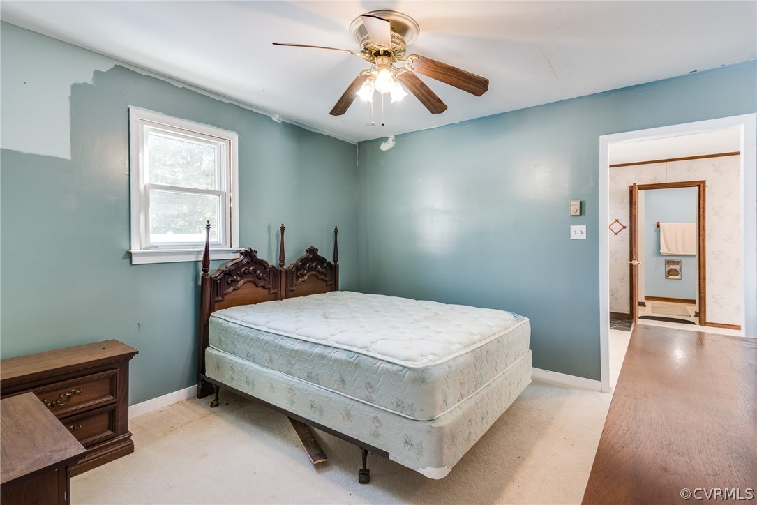 11711 Genito Road Midlothian, VA 23112 - Photo 15 of 18 a bedroom with a bed and a chandelier