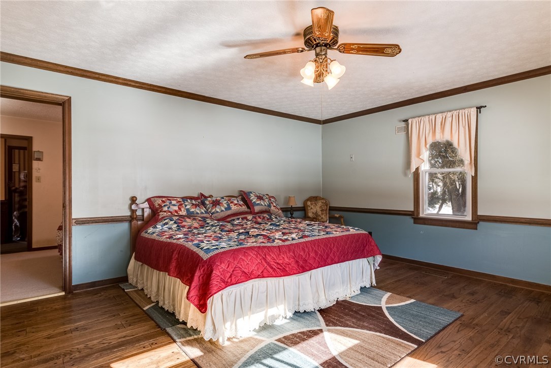 11711 Genito Road Midlothian, VA 23112 - Photo 4 of 18 a bedroom with a bed and wooden floor