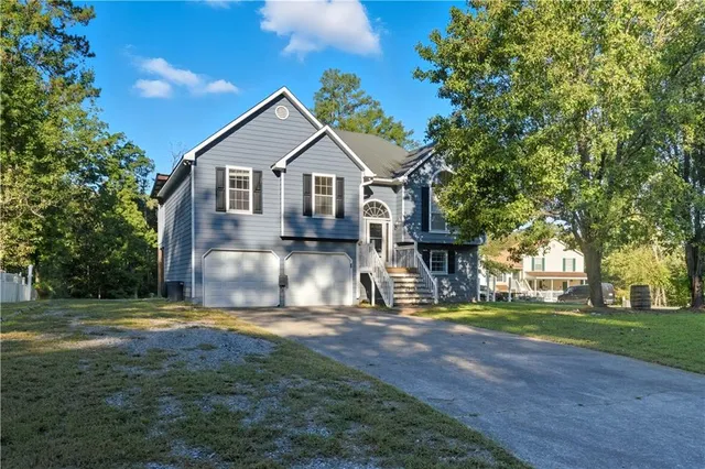 a view of a house with yard and tree s