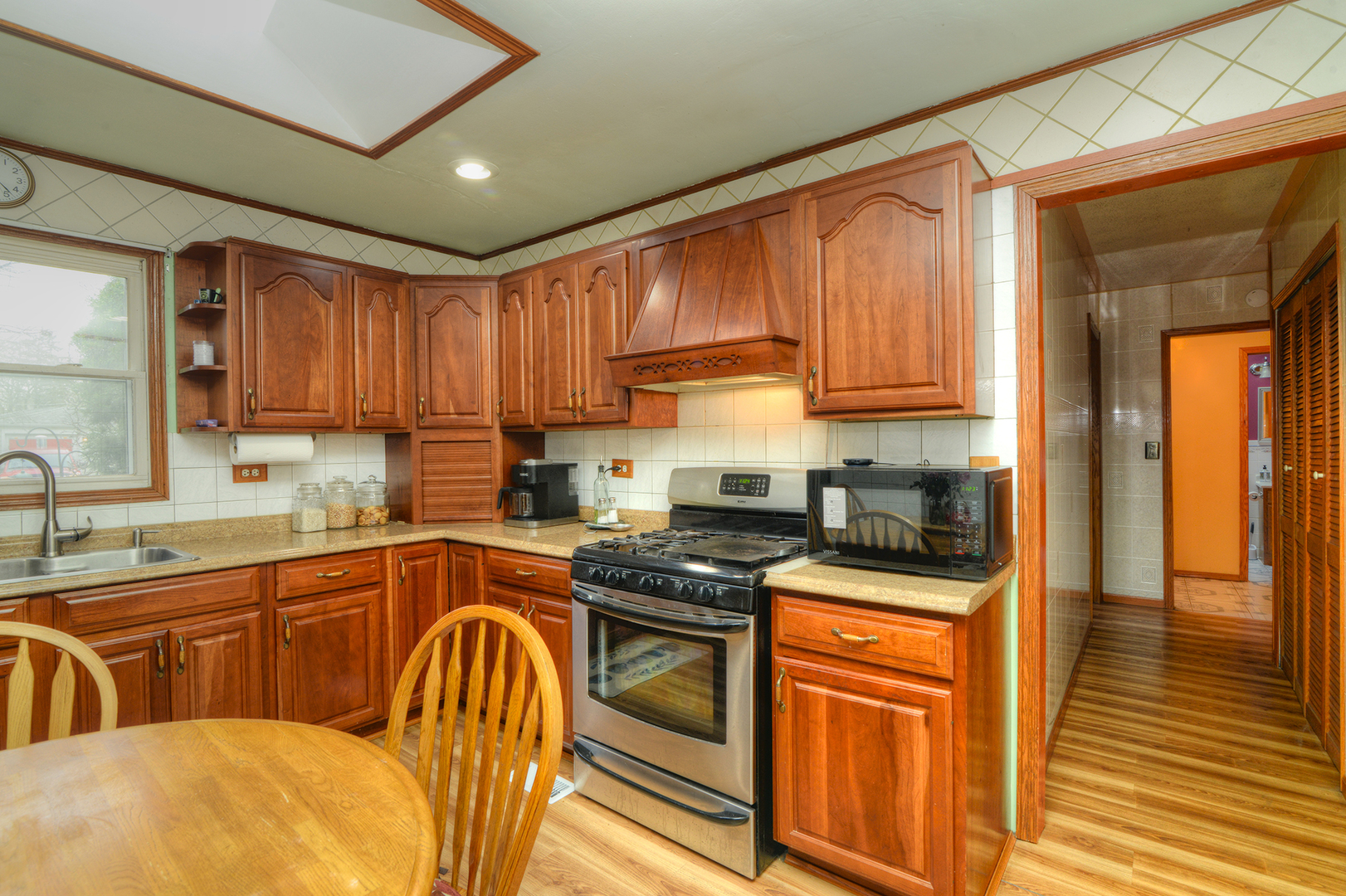 5 Butterfield Road Lake Zurich, IL 60047 - Photo 7 of 32 a kitchen with stainless steel appliances granite countertop a sink a stove cabinets counter space and a window