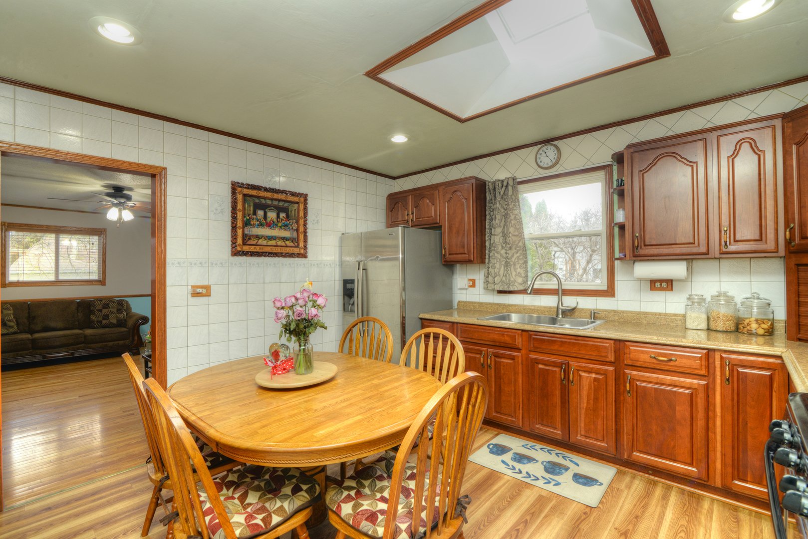 5 Butterfield Road Lake Zurich, IL 60047 - Photo 8 of 32 a kitchen with stainless steel appliances granite countertop a sink a stove a dining table and chairs
