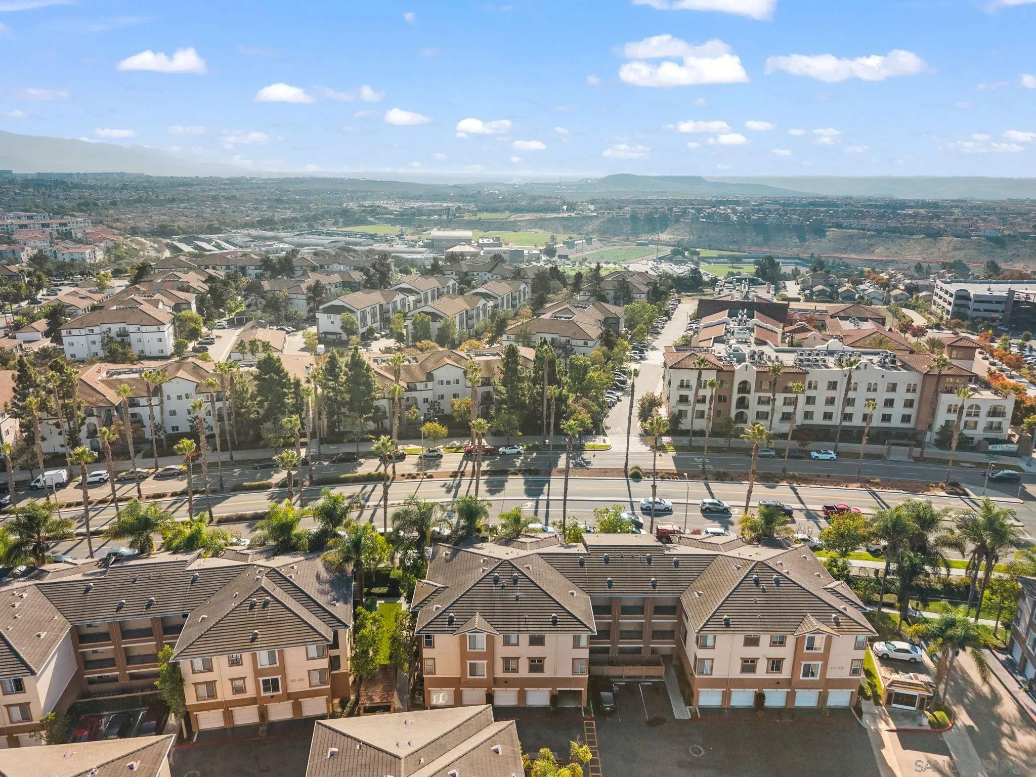 an aerial view of residential houses with city view