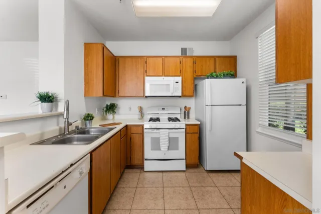 a kitchen with a refrigerator sink and stove