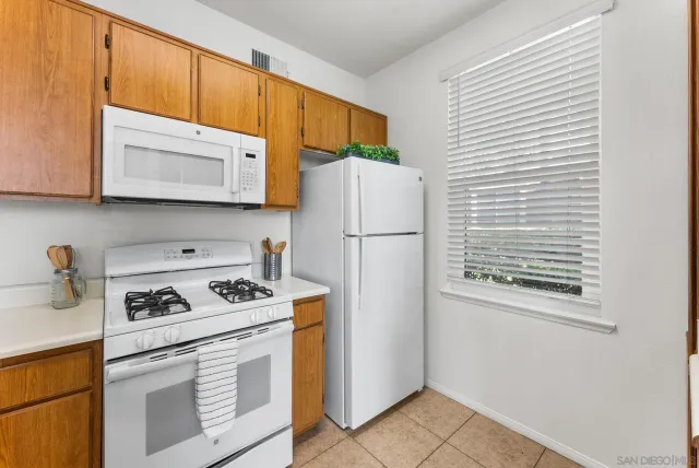 a kitchen with a refrigerator and a sink