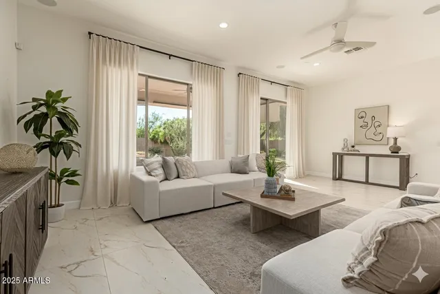 a living room with furniture and a view of kitchen