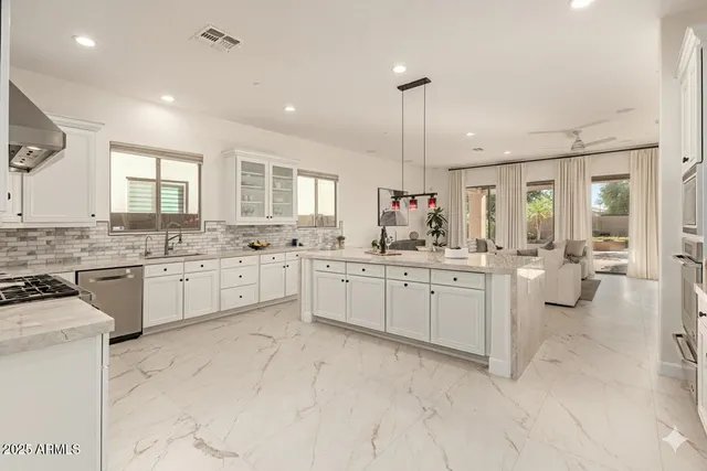 a large kitchen with a table and chairs