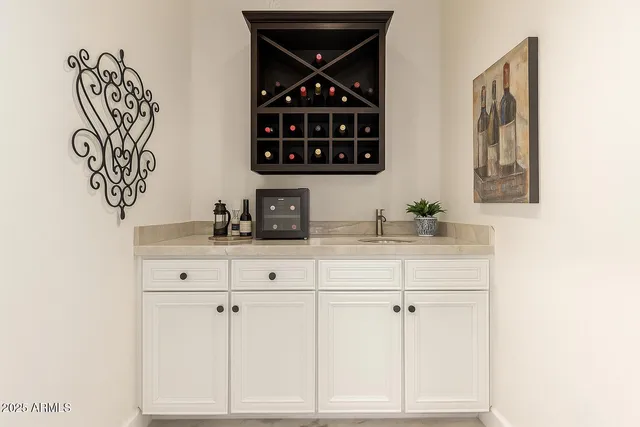 a kitchen with stainless steel appliances granite countertop a table and chairs in it