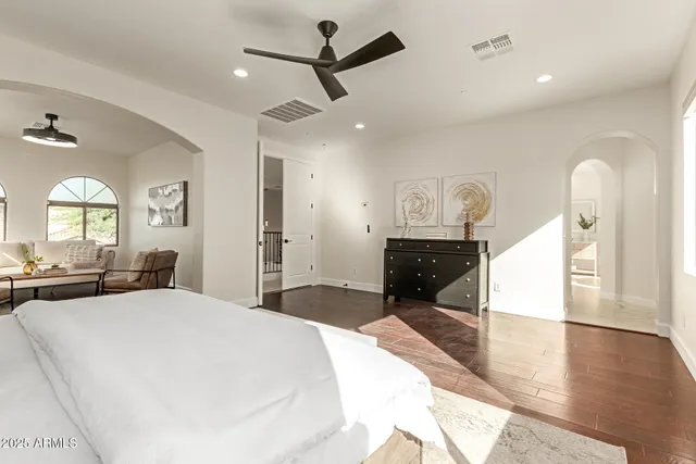 a spacious bedroom with a large bed and a window