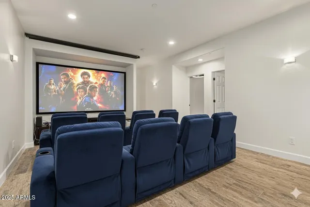 a living room with furniture a projector and a flat screen tv