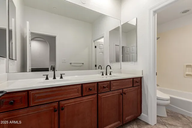 a living room with furniture a rug and a flat screen tv