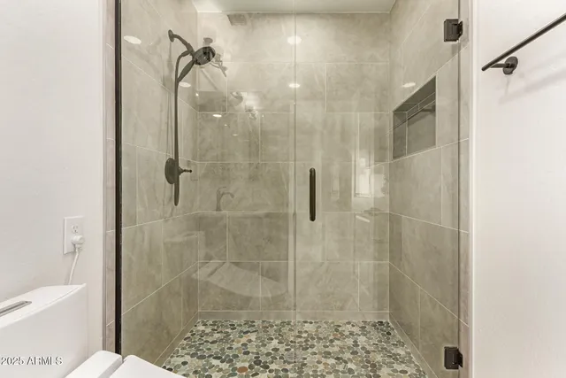 a bedroom with a large bed and a window