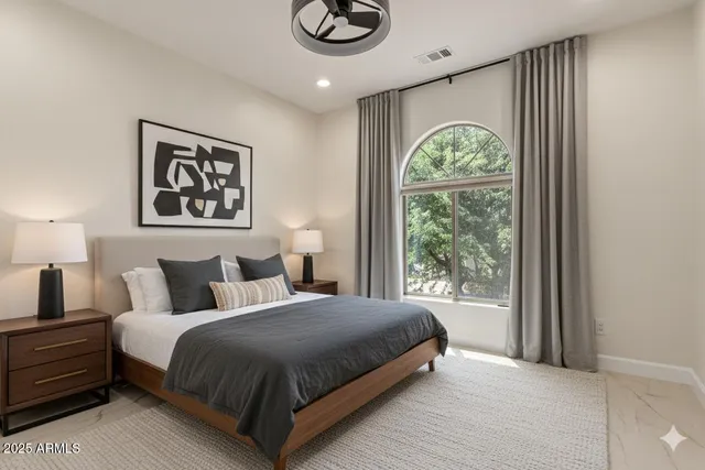 a bedroom with a bed and a window