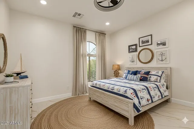 a bedroom with a bed and a large window