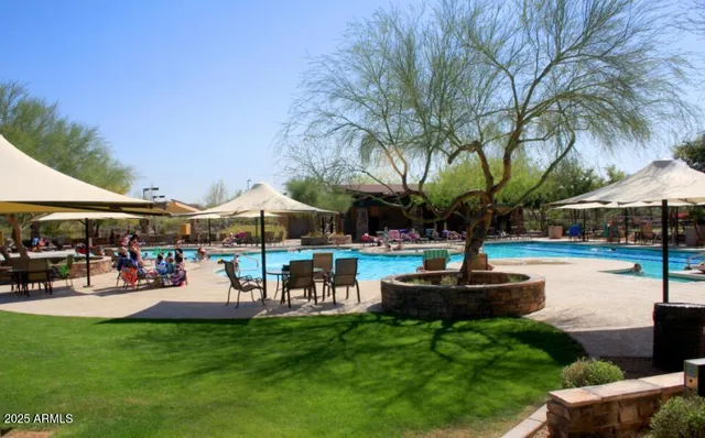 view of a house with a yard and sitting area