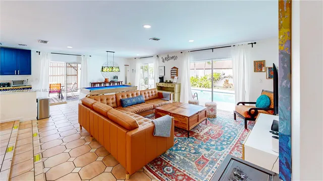a kitchen with stainless steel appliances granite countertop a refrigerator sink and wooden cabinets