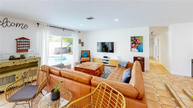 a view of living room kitchen with furniture and window