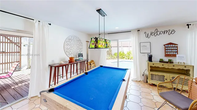 a living room with furniture a flat screen tv and a window