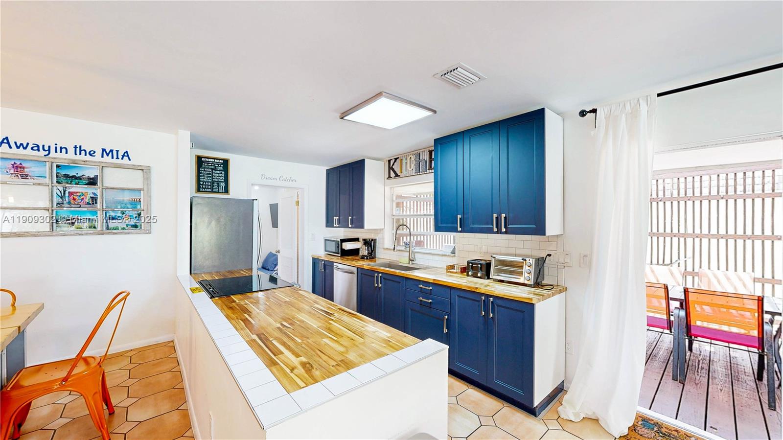 9614 Southwest 134th Court Miami, FL 33186 - Photo 18 of 69 a kitchen with stainless steel appliances kitchen island granite countertop a refrigerator a sink dishwasher a dining table and chairs with wooden floor
