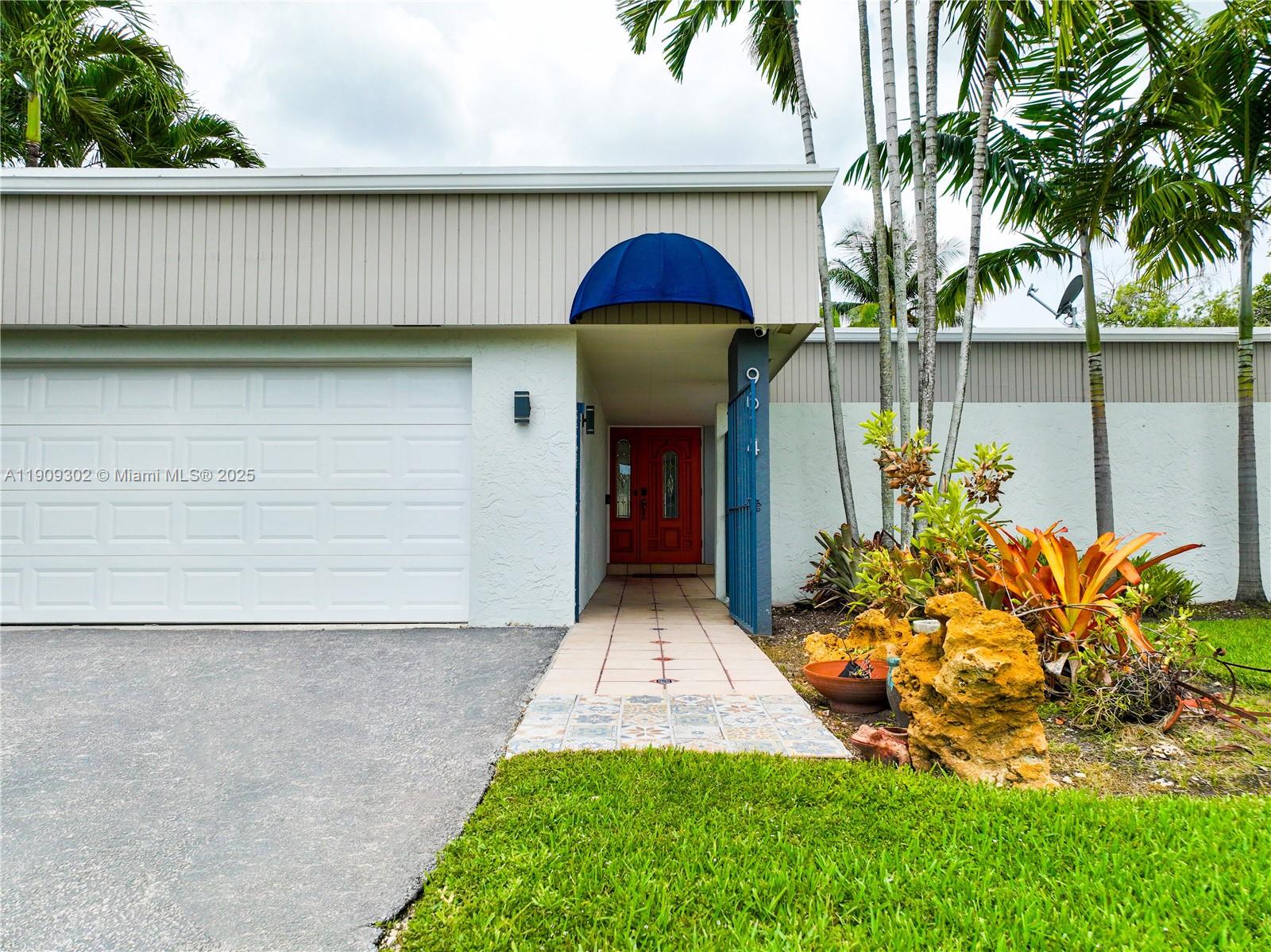 9614 Southwest 134th Court Miami, FL 33186 - Photo 4 of 69 a front view of a house with garden