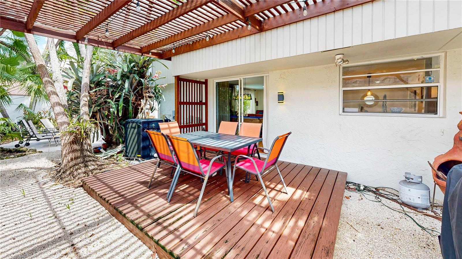 9614 Southwest 134th Court Miami, FL 33186 - Photo 41 of 69 a view of a patio with table and chairs with wooden floor and fence