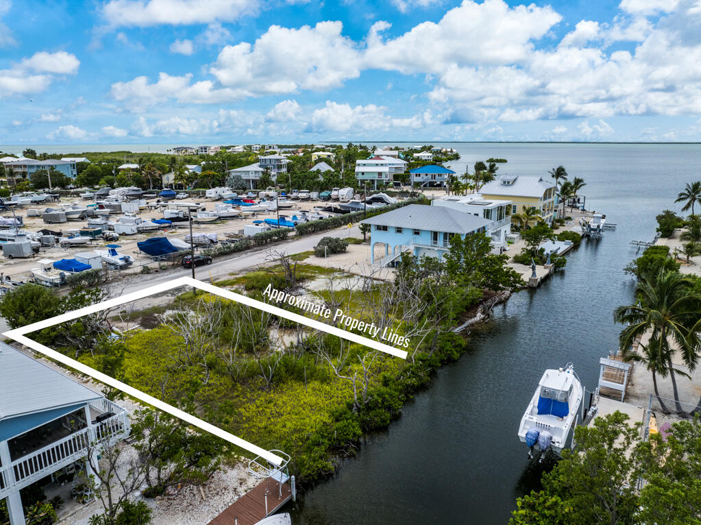 7 Calico Jack Circle Cudjoe, FL 33042 - Photo 2 of 17 an aerial view of a house with swimming pool and lake view in back