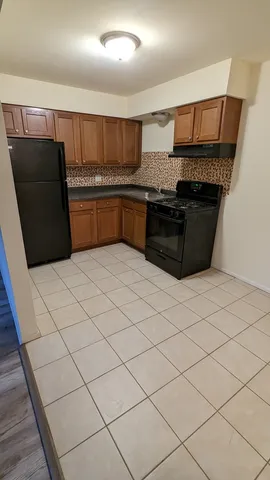 a kitchen with stainless steel appliances a stove a sink and a refrigerator