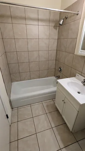 a bathroom with a bathtub and shower