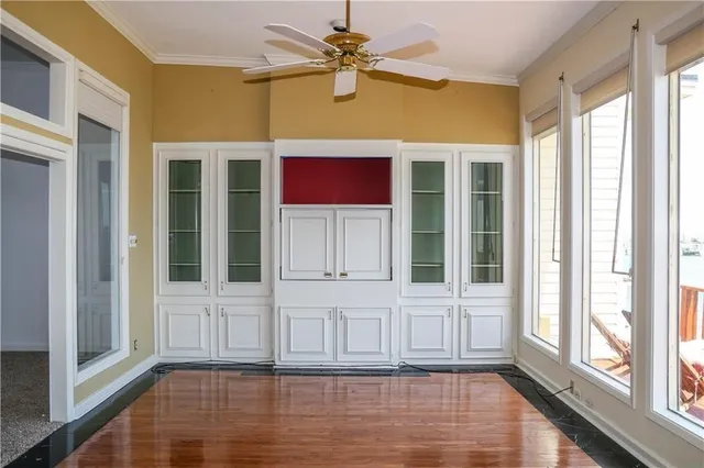 a view of a room with a window and wooden floor